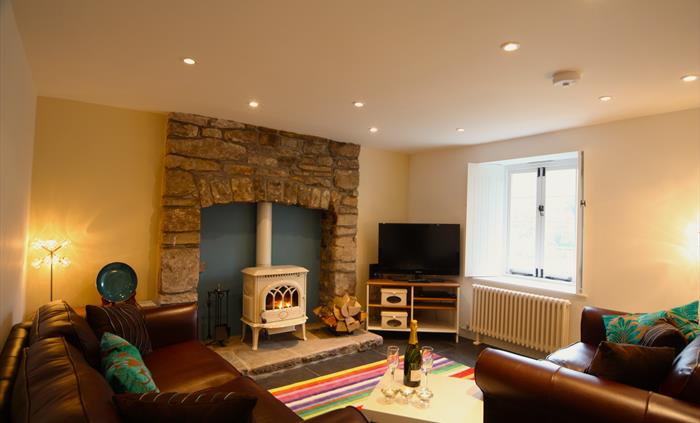 Tintern Abbey Cottage cosy sitting room  with woodburner and Tintern Abbey view